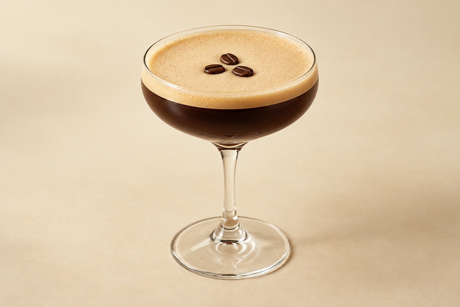 Espresso Martini in a coupe with fine foam and three coffee beans on an ivory background. AI-generated illustration.